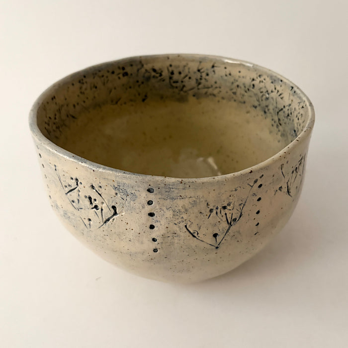 Medium sized bowl with blue imprints