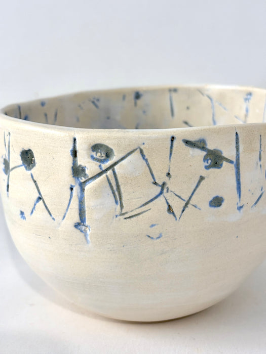 Medium sized bowl with blue imprints